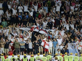 English fans celebrate after beating Sweden during the Euro championships in Kiev on June 15, 2012.  (Jonathan Nackstrand/AFP)