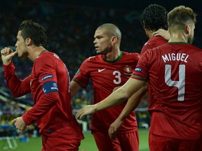 Portuguese forward Cristiano Ronaldo (L) celebrates with teammates after scoring against the Netherlands. (AFP)