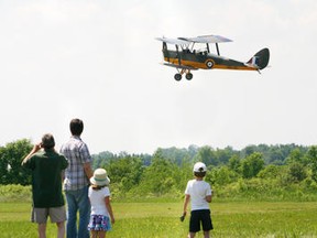 Wesley Alexander, 12, takes to the skies with pilot Bryan Quickmore of the Edenvale Classic Aircraft Foundation in a 1940 DH-82A Tiger Moth at the KawarthaâClassics Fly-In and Antique Car Show at the Lindsay Airport, hosted by the Kawartha Lakes Flying Club, on Sunday, June 10, 2012. The Second World War trainer is the only one remaining in its originalâBritish configuration in North America. JASON BAIN/The Lindsay Post