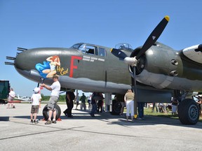 Members of the public check out the B-25 bomber at the 2012 Wings and Wheels event.