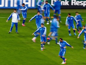 Greece's national soccer players warm up during a training session before their Euro 2012 soccer match against Germany in the PGE Gdansk Stadium in Gdansk, June 21, 2012. (REUTERS)
