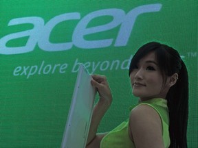 A model displays a lotop beside an Acer logo during the Computex 2012 in Taipei on June 5, 2012. (AFP/SAM YEH)