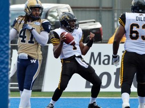 Hamilton Tiger-Cats quarterback Henry Burris (centre) dances after a touchdown during Wednesday’s pre-season game against the Bombers. The Ticats won 26-25. (FRED GREENSLADE/Reuters)