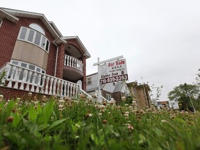 A "for sale" sign is seen outside a home. REUTERS/Shannon Stapleton