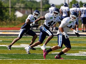 The Argonauts’ Pacino Horne, left, Raymond Brown and Matt Estrada run drills during training camp recently in Mississauga.