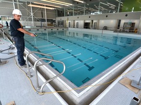 Al Nightingale, the director of facilities for the Owen Sound Family Y takes a reading of the water temperature in the new pool at the Y's new home in the Regional Recreation Centre at Victoria Park in Owen Sound. WILLY WATERTON/OWEN SOUND SUN TIMES/QMI AGENCY