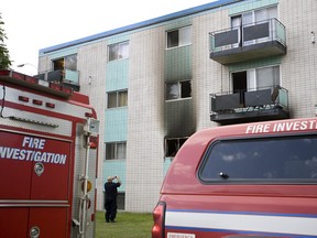 Edmonton Fire Rescue Services investigators spent the morning investigating after an early morning fire in a low-rise apartment complex at 8516 99 Street in Edmonton, Alberta, on July 8, 2012. Three men and a woman were taken to hospital. The woman is being treated for burns while the three men are being treated or smoke installation. IAN KUCERAK/EDMONTON SUN/QMI AGENCY