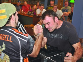 Sylvain Bissonnette grimaces while arm-wrestling against Joel Goodsell during one of three intense supermatches at Saturday's Prescott Arm Wrestling Championships.
(NICK GARDINER/The Recorder and Times)