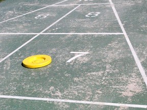 In shuffleboard, players earn points by landing their discs within certain point ranges. Players can knock the discs of others. 
CHAD INGRAM/MINDEN TIMES/QMI AGENCY