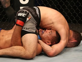 Chris Weidman (top) attempts to submit Mark Munoz during their middleweight bout at UFC on Fuel TV 4 on Wednesday night.