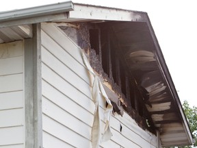 Damage can be seen to a house south of 34 Avenue on 48 Street, after it was reportedly struck by lightening in Edmonton, Alberta on Thursday, July 12, 2012.  AMBER BRACKEN/EDMONTON SUN/QMI AGENCY
