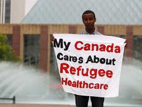 Bashir Mohamed, 17, poses for a photo outside of Edmonton City Hall in Churchill Square in Edmonton, Alberta, on July 15, 2012. Mohamed was removed from a Conservative Party of Canada barbecue for asking  Immigration Minister Jason Kenney about cuts to refugee claimants healthcare benefits. Mohamed came to Canada when he was three years old. He said he was arrested by security personnel after he tried to unfurl a banner at the event. IAN KUCERAK/EDMONTON SUN/QMI AGENCY