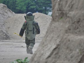 A member of the Barrie Police Explosive Disposal Unit begins the task of detonating nine pipe bombs taken from 30 Virgilwood Cres. over the weekend. (QMI Agency)