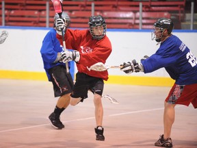 Allberg Electric team member Ryan Labonte sidesteps a check from First Ontario Credit Union’s Jeff Pearson during the Simcoe Minor Lacrosse Association’s 5th annual Rock the Box event. The 11-hour game raised about $2,500 for the local organization. (JACOB ROBINSON Simcoe Reformer)
