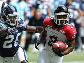 Brandon Isaac of the Toronto Argos chases down Larry Taylor of the Stampeders in the first half of action at the Rogers Centre in Toronto on July 7, 2012. (DAVE ABEL, QMI Agency)