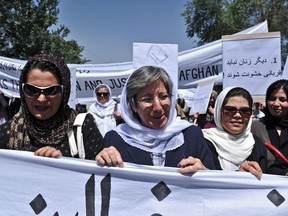 Afghanistan head of Human Rights Commision Seema Samar (C) marches with Afghan women to protest the recent public execution of a young woman for alleged adultery, in Kabul on July 11, 2012. (AFP/MASSOUD HOSSAINI)