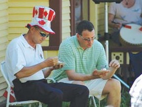 Kenora Mayor Dave Canfield (left) and Kenora MP Greg Rickford share a bit of shade as they enjoy a slice of Canada Day birthday cake at the Mather Walls House on July 1.
BRENDA STEWART/Daily Miner and News