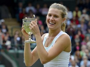Eugenie Bouchard of Canada holds her trophy after defeating Elina Svitolina of Ukraine in their girls' final tennis match at the Wimbledon tennis chamionships in London July 7, 2012.  REUTERS/Toby Melville