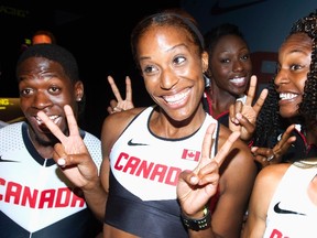 Canadian Olympic athlete Phylicia George (C) gestures at reporters along with other Olympic athletes during a press conference held by Nike and Athletics Canada to unveil Canadian Olympic team apparel in Toronto July 10, 2012. (REUTERS)