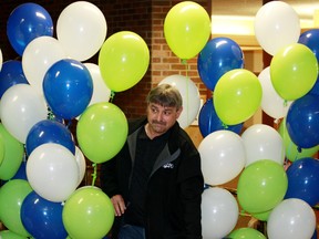 Lotto Max winner Chris Fowler, 55, from Fort McMurray walks through balloons at the Western Canada Lottery office in St. Albert on July 19, 2012. (TOM BRAID/QMI Agency)