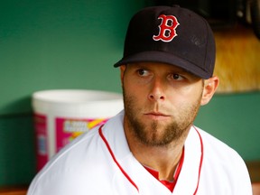 Dustin Pedroia of the Boston Red Sox sits in the dugout prior to the game against the Chicago White Sox on July 19, 2012 at Fenway Park in Boston, Massachusetts. Pedroia played in his first game since coming off of the disabled list. (JARED WICKERHAM/Getty Images/AFP)