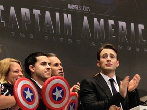 Actor Chris Evans and representatives from Marvel Comics and the movie 'Captain America: The First Avenger' ring the opening bell at the New York Stock Exchange, July 11, 2011.  (Brendan McDermid/REUTERS)