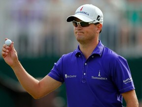 Zach Johnson of the U.S. holds his ball on the 18th green after finishing his third round of the British Open golf championship at Royal Lytham & St Annes, northern England July 21, 2012.  REUTERS/Brian Snyder