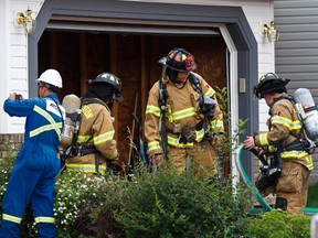 Fire and gas crews respond after a gas explosion caused a house fire in west Edmonton on Monday. CODIE MCLACHLAN/EDMONTON SUN QMI AGENCY