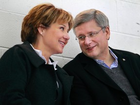 Canadian Prime Minister Stephen Harper (R) and B.C. Premier Christy Clark chat as Clark's 10 year-old son plays during a minor league hockey game in Vancouver, January 12, 2012. (REUTERS/Handout)