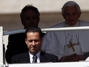 The Pope's butler Paolo Gabriele (bottom L) arrives with Pope Benedict XVI (R) at St. Peter's Square in Vatican, in this May 23, 2012 file photo. (Reuters/ALESSANDRO BIANCHI/Files)