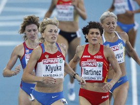 Russia's Svetlana Klyuka (front left) was one of nine track athletes to be handed lengthy bans for doping violations on Wednesday, July 25, 2012. (Albert Gea/Reuters/Files)