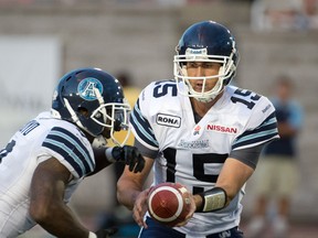 Quarterback Ricky Ray hands off to Cory Boyd during the Argos game against the Alouettes in Montreal on Friday night. (BEN PELOSSE/QMI Agency)