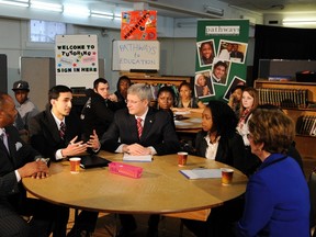 Canada's Prime Minister Stephen Harper talks to students while pledging support for the "Pathways to Education Canada" in Toronto, March 3, 2011.    REUTERS/Mark Blinch