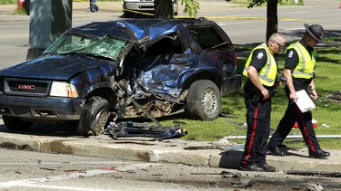Members of the EPS Traffic Section investigate a fatal collision involving a stolen Jeep at 156 St., at 100 Ave., in Edmonton on August. 6, 2012. TOM BRAID/EDMONTON SUN  QMI AGENCY
