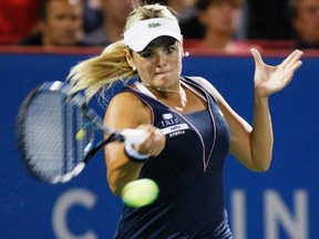 Aleksandra Wozniak hits a return to Daniela Hantuchova during their first-round match at the Rogers Cup in Montreal, Que., Aug. 7, 2012. (CHRISTINNE MUSCHI/Reuters)