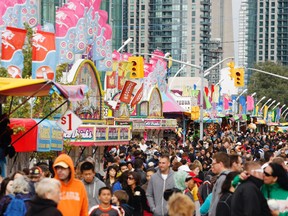 People flock to the midway at the CNE in Toronto. (Mark O'Neill/QMI Agency)