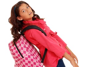 A backpack that fits properly is a must — children can cause pain and damage to their spine by carrying a backpack that is not the right height and is too heavy. (Fotolia)
