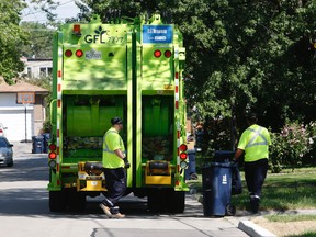 A GFL crew picks up garbage. (MICHAEL PEAKE/Toronto Sun files)