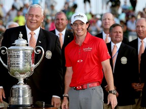 PGA of America President Allen Wronowski poses with Rory McIlroy of Northern Ireland and the Wanamaker Trophy during the Final Round of the 94th PGA Championship at the Ocean Course on August 12, 2012 in Kiawah Island, South Carolina. (Andrew Redington/Getty Images/AFP)