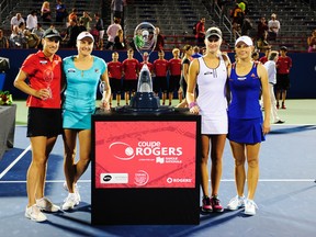 Katarina Srebotnik of Slovenia, Nadia Petrova of Russia, runners up, and Kristina Mladenovic of France and Klaudia Jans-Ignacik of Poland, winners, pose with the trophies on August 12, 2012. (Robert Laberge/Getty Images/AFP)