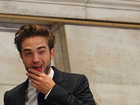Robert Pattinson rings the opening bell at the New York Stock Exchange, August 14, 2012. REUTERS/Brendan McDermid