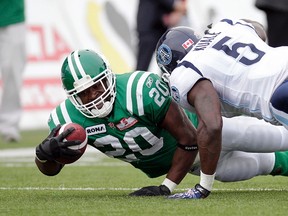 Roughriders running back Wes Cates gets tackled by Argonauts linebacker Ejiro Kuale. Argos coach Scott Milanovich says he has been impressed with Kuale’s effort both on and off the field.