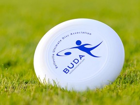 A Frisbee denoting the Belleville Ultimate Disc Association or BUDA logo is pictured rolling in the grass. The league formed in the spring of 2012 is looking for more players to round out their fall league beginning September 11, 2012. Photo: Michael J Brethour