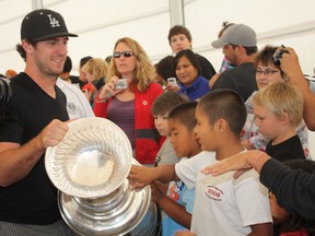 Kenora fans get a chance to reach out and touch the Stanley Cup carried away by Kenora's Mike Richards after a two-hour celebration under the Whitecap Pavilion on Saturday, Aug. 18, 2012. (LLOYD MACK/QMI AGENCY)
