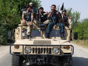 Afghan security force on sit top of a military vehicle in Laghman province on Aug. 15, 2012. US Defence Secretary Leon Panetta said on Aug. 14 he was very concerned about the rise in insider attacks on US and NATO troops, and the impact they are having on cooperation with Afghan allies.  AFP PHOTO/ Waseem Naikzad