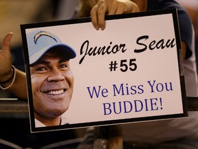 A fan holds up a sign honoring late San Diego Chargers linebacker Junior Seau during the game against the Green Bay Packers at Qualcomm Stadium on August 9, 2012 in San Diego, California. The Chargers won 21-13. (Stephen Dunn/Getty Images/AFP)