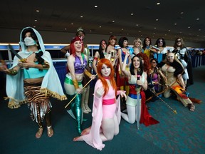 Attendees wearing costumes pose for a photo during Comic-Con international convention in San Diego, California July 13, 2012.  (REUTERS/Mario Anzuoni)