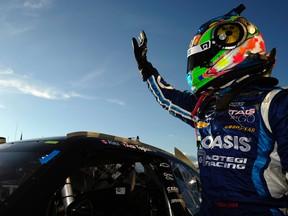 Alex Tagliani waves to the crowd after his qualifying run for the NASCAR Nationwide Series sixth annual Napa Auto Parts 200 at the Circuit Gilles Villeneuve in Montreal yesterday. (Robert Laberge/Getty Images/AFP)