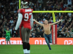 A man runs on the field during the NFL football game between the Chicago Bears and the Tampa Bay Buccaneers at Wembley Stadium, in London, October 23, 2011.   (REUTERS)