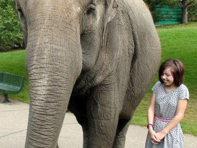 Maddie Dawson (12), recipient of this year's Stollery Hospital Child Champion award, poses with Lucy the Elephant at the Edmonton Valley Zoo in Edmonton on August 23, 2012. AARON TAYLOR/EDMONTON SUN QMI AGENCY